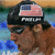 Pixelated image of a person wearing dark sunglasses and a black cap with an American flag design, set against a blurred background.
