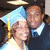 Two pixelated figures with light skin tones, one wearing a blue and white outfit with a yellow staff and halo, the other in a dark blue suit with a white collar, positioned closely together.