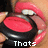 A close-up of a person's mouth holding a black and red object with text below.
