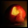 A red apple with a heart-shaped cutout revealing yellow flesh, resting on a dark surface with 'sweet love' text below.