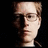 A red background displays a pixelated portrait of a person with light hair and glasses, alongside text reading "FORGET JOANNE," "WE LOVE," and "MARK!!<3" in black block letters.