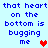 Pixelated blue text on light blue background reads 'that heart that heart on the bottom is bugging me' with red and pink hearts.