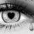 A grayscale eye with a heart-shaped pupil, black eyelashes, and a single tear drop below the eye, rendered in pixelated style.