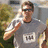 Pixelated image of a person in a gray shirt with a white graphic, holding a phone to their ear, surrounded by purple text reading "there is my DADDY!!! he looks funny".