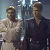 Pixelated static image of two human figures standing side-by-side in a dimly lit environment with blue and gray tones.