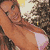 Pixelated static image of a person in a bikini top with visible chest area, set against an indistinct background with light and dark tones.