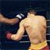 Static pixelated image of a shirtless boxer in mid-punch with blurred background and visible motion blur on the arm.