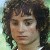Pixelated portrait of a person with dark curly hair, light skin, and closed eyes against a greenish background.