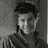 Black-and-white pixelated image of a person with short hair and a striped shirt, next to text reading 'back off i am mrs.efron' on a black background.