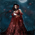 A pixelated figure in a long red gown stands against a dark blue background with scattered light particles.