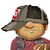 Pixelated cartoon character wearing gray cap with red 'S' logo, red and blue striped shirt, holding brown object, smiling expression.