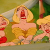 Three cartoon women with blonde hair and red lips sit in a row, one with mouth open wide in a scream, another covering her face, and the third with a strained expression.