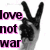 A hand making a peace sign with text reading 'love not war' in pink and black, displayed