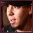 Pixelated close-up of a person's face with dark hair, showing slight mouth movement