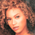 A 2x2 contact sheet of a pixelated animated icon featuring two identical frames with curly-haired woman and one frame with text on blue background, all in low-resolution pixels.