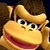 Pixelated close-up of a cartoon monkey face with brown hair, large eyes, and a wide open mouth showing red interior.