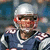 A football player in a blue jersey with white and red accents, wearing a silver helmet, appears in a of four with one blank