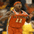 A basketball player in an orange jersey with number 11 appears on the left, while a white jersey version of the same player is shown on the right.