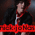 Pixelated image of a person with dark hair wearing a black jacket over red clothing, standing against a dark background with red text at the bottom.