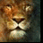 A pixelated close-up of a lion's face with brown and tan fur, dark eyes, and a black nose against a blurred greenish background.