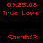 Red pixelated text on black background displays date, title, and name with heart symbol in two identical side-by-side