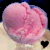 A static pixelated image of a pink, rounded object with subtle darker pink and purple shading against a dark background.