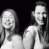 Static grayscale buddy icon showing two smiling figures with long hair against a black background, rendered in low-resolution pixel art style.