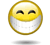 Animated yellow circular face with closed eyes and a wide grin showing teeth, wearing a white mask-like covering over the lower half of its face.