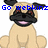 Pixelated cartoon dog with tan body, black face and ears, red eyes, and pink mouth, sitting with text "Go webkinz" above.