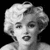 Black-and-white pixelated image of a person with light-colored hair styled in voluminous waves, closed eyes, and slightly parted lips against a solid black background.