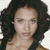 Static pixelated portrait of a person with dark curly hair, light skin tone, and neutral expression against white background.