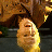 Pixelated static image of a yellow running stick figure with brown background elements and dark water-like foreground, likely from an old AOL Instant Messenger buddy icon.