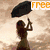 A pixelated image shows a woman holding a black umbrella on a beach with a cloudy sky, while the word 'free' appears in orange text at the top right.