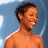 A 48x48 pixel animated contact sheet showing three frames of a person with short dark hair against different backgrounds and a blue oval "American Idol" logo on black background.