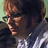 Pixelated image of a person with short brown hair and glasses, wearing a checkered shirt over dark clothing, next to text reading "My Favorite Criminal" on white background.