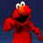 Two side-by-side pixelated images of a red puppet character with large eyes and an orange nose, one against dark blue background the other on light beige.