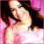 Pixelated image of a person with dark hair wearing pink clothing against a black and purple background.