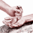 Pixelated image of a hand gripping another hand with fingers curled around, set against white background.