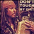 A pixelated image of a person with long hair holding up hands in front of their face, with text reading "DON'T TOUCH MY DIRT!!" displayed over the scene.