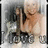 A pixelated animated icon shows a person with light hair holding a dark object, wearing dark shorts against a blurred background.