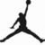 Black silhouette of a basketball player mid-jump holding a ball, displayed in a with one frame partially cropped