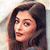 Static pixelated image of a woman's face with long dark hair, light skin tone, and neutral expression against a gradient background.
