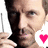 Pixelated close-up of a person holding a microphone with a pink heart symbol on the right side.