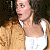 A 50x50 pixel animated contact sheet showing two frames of a woman in a white tank top and brown jacket on the left, with green text "Original Icons .com" on a dark green background to the right.