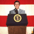 A person stands behind a podium with the presidential seal, in front of red and white striped background; text reads 'Gary For President '08' on right side.