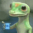 Pixelated green lizard-like creature with large black eyes and orange accents on its head, holding a blue rectangular object with a white plus sign.