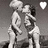 Two figures in grayscale pose closely together with a heart symbol above them, rendered as low-resolution pixel art.