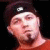 A person in a red shirt and dark headband appears with changing text overlays on black background.