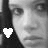 Black-and-white pixelated image of a person's face with a white heart symbol in the bottom-left corner, split into two side-by-side sections.