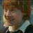 Pixelated image of a person with red hair and a white-collared shirt, alongside green text reading 'I Love Ronald Billius Weasley' on black and gray backgrounds.